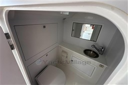 2017 VanDutch 40 yacht bathroom with sink, mirror, and toilet in sleek white design.