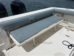 2005 Boston Whaler 320 Outrage boat with cushioned seating and dual outboard motors.