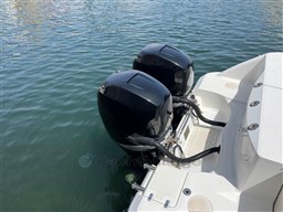 Twin outboard engines on a 2005 Boston Whaler 320 Outrage in calm water.
