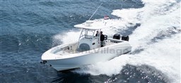 2005 Boston Whaler 320 Outrage boat cruising on open water.