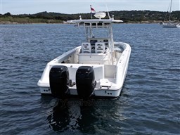 2005 Boston Whaler 320 Outrage boat on water, dual engines, scenic background.