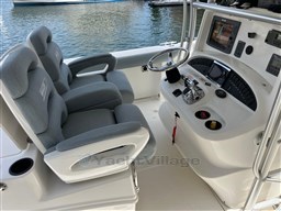 2005 Boston Whaler 320 Outrage boat cockpit with dual seats and control panel.