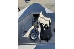 Anchor compartment of a 2005 Boston Whaler 320 Outrage boat, featuring chain and winch.