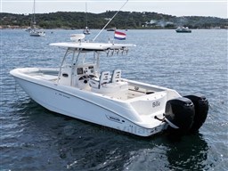 2005 Boston Whaler 320 Outrage boat on water, featuring dual engines and sleek design.