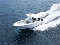 2005 Boston Whaler 320 Outrage cruising on open water, showcasing sleek design and powerful performance.