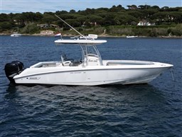 2005 Boston Whaler 320 Outrage boat on calm water, side view.