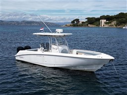 2005 Boston Whaler 320 Outrage boat anchored in scenic coastal waters.