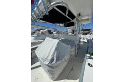 2005 Boston Whaler 320 Outrage boat interior with covered console, docked at marina.