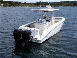 2005 Boston Whaler 320 Outrage boat with dual engines on calm water.