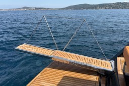 2022 Pardo Yachts P43 swim platform extended over blue ocean waters.