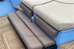 Luxury seating on a 2004 Wally 45 yacht with quilted cushions and teak flooring.