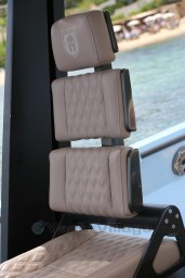 Luxurious beige seat on a 2004 Wally 45 yacht, featuring diamond stitching and carbon fiber accents.