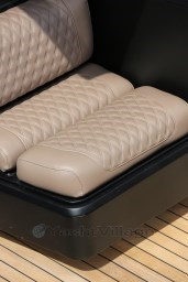 Luxurious beige leather seats with diamond stitching in a 2004 Wally 45 yacht.