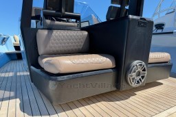 Luxury seating on 2004 Wally 45 yacht with speaker, teak deck background.