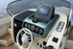 2023 Invictus GT 280 boat dashboard with steering wheel and navigation controls.