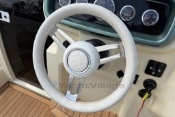 Steering wheel of 2023 Invictus GT 280 boat with dashboard controls.