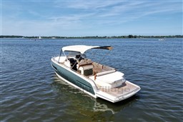 2023 Invictus GT 280 boat on calm water under clear blue sky.