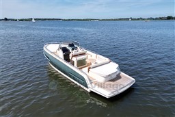 2023 Invictus GT 280 boat on calm water, showcasing sleek design and spacious deck.