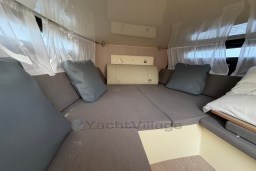 Interior of 2023 Invictus GT 280, featuring cozy seating with cushions and elegant curtains.
