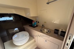 Modern bathroom interior of 2023 Invictus GT 280 yacht with toilet and sink.