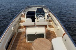 2023 Invictus GT 280 boat interior with wooden deck and modern controls.