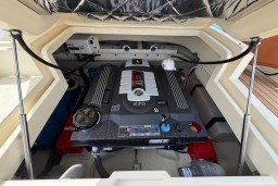 Engine compartment of 2023 Invictus GT 280 boat, showcasing powerful motor and components.