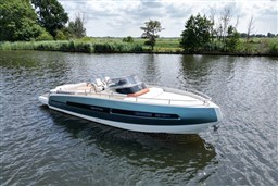 2023 Invictus GT 280 boat on a serene lake with lush greenery.