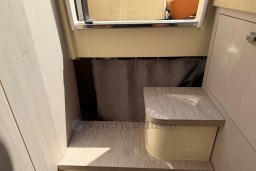 Interior of 2023 Invictus GT 280, featuring wooden steps and a window.