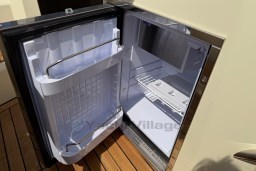 Open refrigerator on Invictus GT 280 yacht, showcasing interior storage and shelving, 2023 model.