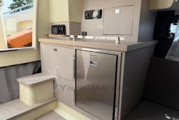 2023 Invictus GT 280 yacht interior with modern kitchenette and sleek cabinetry design.