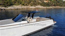 2019 Pardo Yachts 43 cruising on serene waters near a rocky coastline.