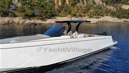 2019 Pardo Yachts 43 cruising near rocky coastline with lush greenery.