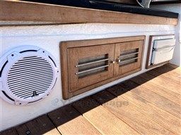 Wooden deck and storage on 1978 Sloop 785 boat with speaker and vent.