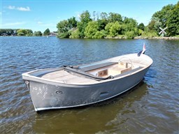 1978 Sloop 785 boat on a serene lake with lush green trees.