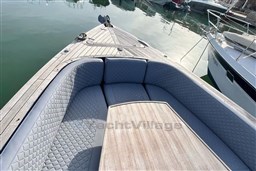 Luxurious seating on a 2017 Fjord 36' Open boat, docked in calm waters.