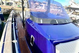 2017 Fjord 36' Open boat with sleek blue exterior docked at marina.