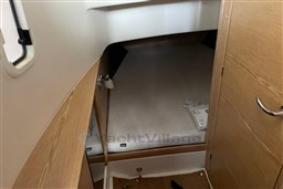 Cozy cabin interior of 2017 Fjord 36' Open boat with wooden accents.