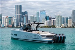 Luxury Pardo Yachts P43R 2026 cruising near city skyline on turquoise waters.
