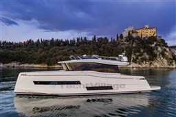 2025 Pardo Yachts Endurance 60 cruising near a scenic coastal castle.