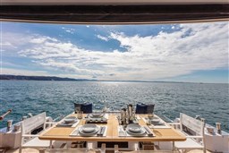 Luxurious dining setup on Pardo Yachts Endurance 60, 2025, overlooking serene ocean view.