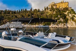 2025 Pardo Yachts Endurance 60 cruising near a scenic coastal castle.