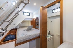 2025 Pardo Yachts Endurance 60 cabin interior with bed, laptop, and compact bathroom.