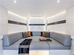 Luxurious interior of 2025 VanDutch 56 yacht with modern seating and elegant decor.