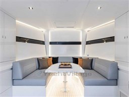 Luxurious interior of 2025 VanDutch 56 yacht with modern seating and elegant design.
