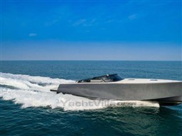 2025 VanDutch 56 yacht cruising on open sea under clear blue sky.