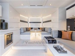 Luxurious interior of 2025 VanDutch 56 yacht with modern seating and elegant decor.