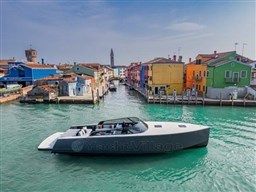 VanDutch 56 yacht cruising through colorful canal, 2025 model.