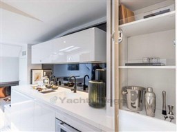 Luxurious interior of 2025 VanDutch 56 yacht with modern kitchen amenities.