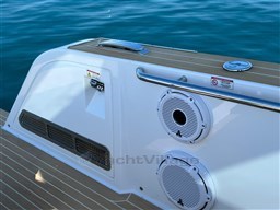 2023 Pardo Yachts 38, sleek deck design with speakers, on calm blue water.