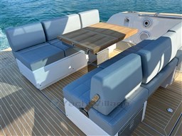 Luxury seating area on 2023 Pardo Yachts 38, featuring elegant design and ocean backdrop.